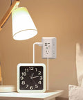 Heavy Duty Surge Protector Wall Charger With Five AC Outlets And Four USB Ports Plugs Fit Perfectly Zero Drama Setup For Home Office Dorm Built In Safety Tech White No Hassle on bedside table with lamp and clock.