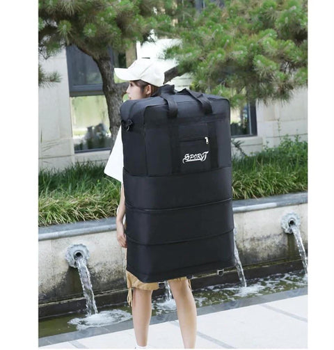 Front view of a large black Oxford travel duffel bag with top handles and a front zipper pocket