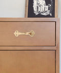 Brass Cabinet Handle 125mm Center To Center Matte Finish Modern Door Pulls for wardrobe drawers on a wooden cabinet.