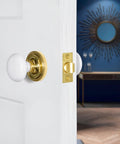 Old School Classic Rosette White Porcelain Round Door Knob For Interior Doors installed on white door with brass finish