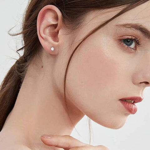 2mm Opal Stud Earrings In Sterling Silver 925 Tiny Ball Cartilage Tragus Piercing Earrings Colorful Opal Mini Jewelry For Women And Girls Hypoallergenic Sensitive Ears Gift on model's ear