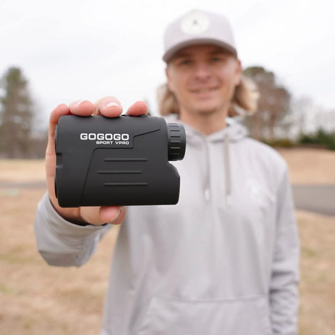 Person holding Laser Rangefinder For Golf And Hunting With 6X Magnification And Precision Distances To 1000 To 1200 Yards Slope