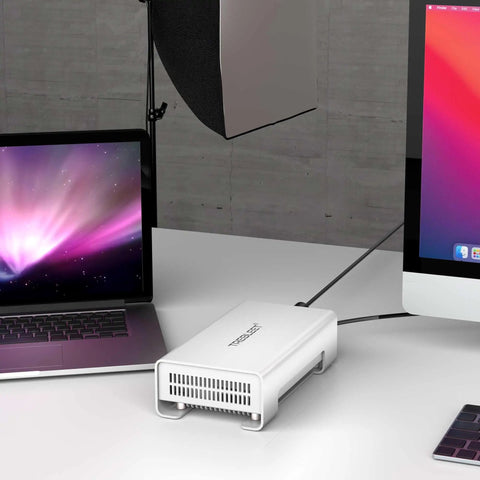 Grab This Top-Shelf Aluminum U.2 NVMe SSD Enclosure USB4 V2 displayed next to laptop and desktop on a desk.