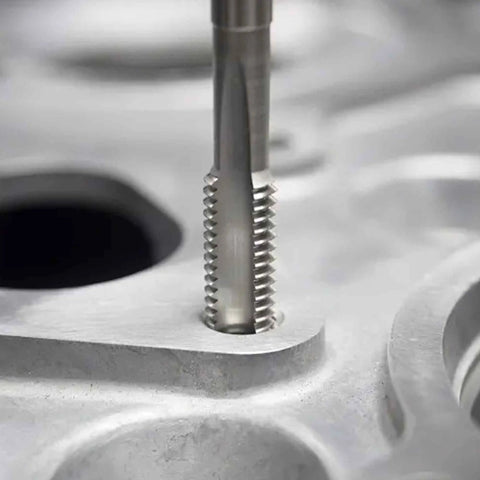 Close-up of Left Hand M3.5 x 0.6 Metric Tap and Die Set for Reverse Thread Repair inserted in mechanical component.