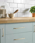 Champagne Bronze Cabinet Pulls 3 Inch Twisted Wave Design Set on modern kitchen drawers, showcasing zinc alloy construction.