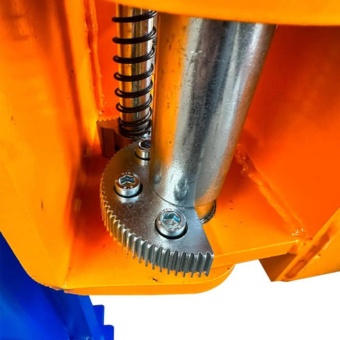 Two-post car lift close-up showing metal gear rack, coil spring, and chrome piston inside orange frame.