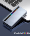 Blazing Fast M.2 NVMe SSD Enclosure With Slick RGB Design And 40Gbps USB4 To Type C Adapter showing RGB lighting next to a laptop.