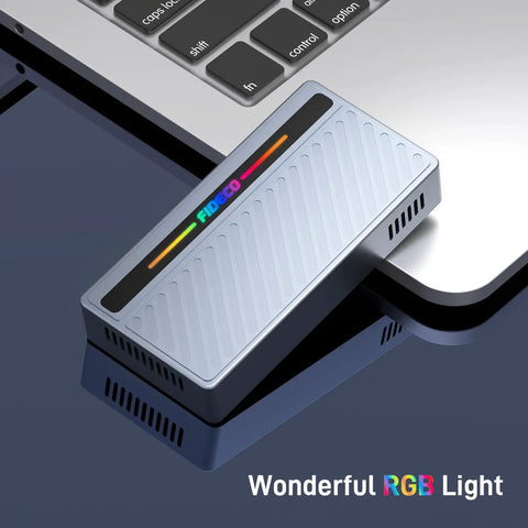 Blazing Fast M.2 NVMe SSD Enclosure With Slick RGB Design And 40Gbps USB4 To Type C Adapter showing RGB lighting next to a laptop.