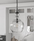 11 Inch Mid Century Modern Pendant Light With Clear Glass Dome Shade And 6 Foot Adjustable Cord For Kitchen Islands, Dining Rooms Or Game Rooms In Blackened Bronze Super Sleek hanging in modern kitchen.
