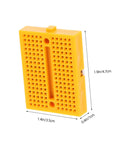 Compact yellow protoboard for rapid circuit assembly, measuring 1.9x1.4x0.4 inches, part of Plug And Play Solderless Breadboard Kit.