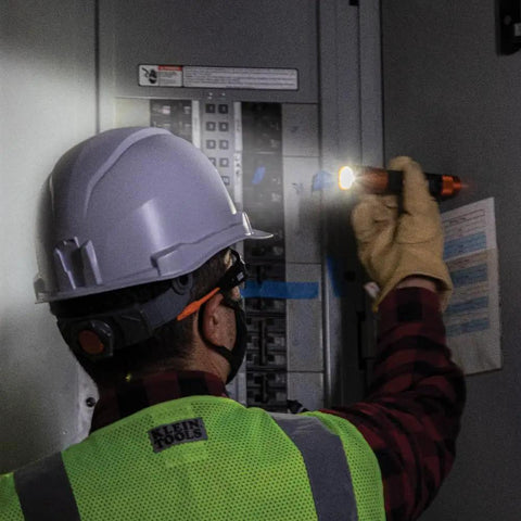 Worker uses Rechargeable 3 In 1 LED Flashlight With Spotlight Floodlight And Red LEDs 1000 Lumens while inspecting electrical panel.