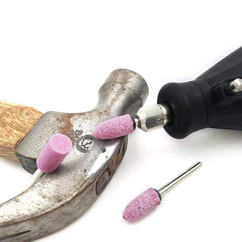 Rotary Tool Grinding Stone Set With One Eighth Inch Shank Aluminum Oxide Bits, 100 Pcs in use on a metal hammer.
