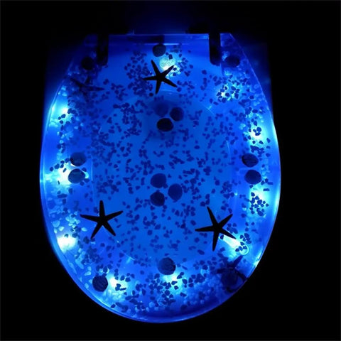 Top Shelf Soft Close Resin Toilet Seat With Built In Led Glow And Heavy Duty Stainless Steel Hinges Quick Release Mounting Kit, illuminated blue design.