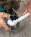 Hands connecting 42-Piece Half Inch PVC Pipe Fittings Elbow Set for greenhouse shed DIY projects and furniture builds.