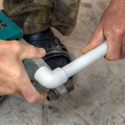 Hands connecting 42-Piece Half Inch PVC Pipe Fittings Elbow Set for greenhouse shed DIY projects and furniture builds.