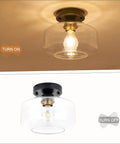 Semi Flush Mount Ceiling Light With Matte Black Finish And 8.66 Inch Clear Hand Blown Glass Shade, Slick Brass Accent Socket.