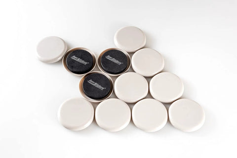 Round Two And Half Inch Reusable Furniture Sliders For Carpet Eight Pack Beige, arranged in a triangular form on a white background.