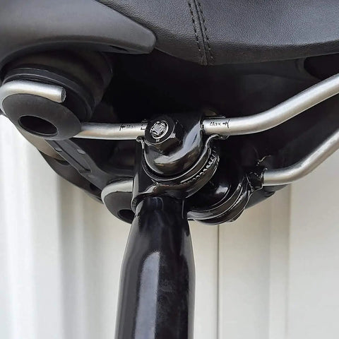 Close view of sturdy bike seat clamp for standard rail saddles, seven eighth inch inner diameter, attached to a bicycle seat.