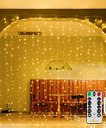 Christmas Curtain Lights 300 LED 9.8 By 9.8 Feet Waterproof Outdoor Curtain String Lights in warm white with remote control and USB.
