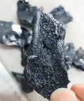 Close-up of High Purity Boron Small Block Crystals 99.99 Percent Metalloids Element For Lab Use 1 To 5 Grams in hand