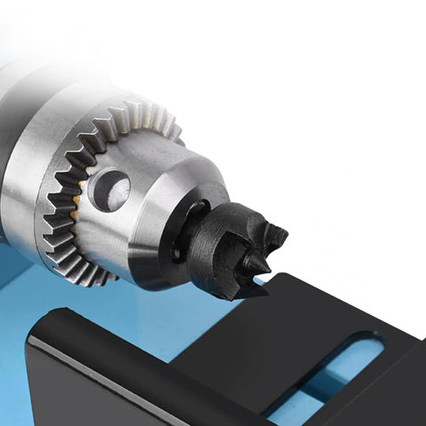 Close-up of Dirt Cheap Mini Wood Lathe For Benchtop Projects Steel Build 150W motor chuck detail with black grip.