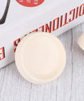 White Rubber Sink Stopper with Hanging Ring 4pcs for Bathtub Drains displayed with a book, showing a top view of the stopper.