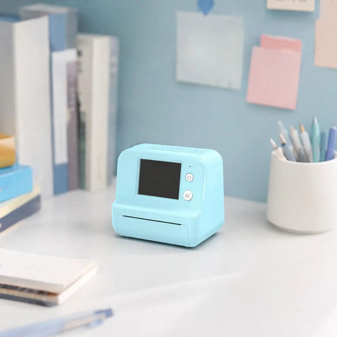 Rock This Slick AI Voice Mini Thermal Printer With Bright Display And Awesome Creative App For Kids Speech To Line Art Drawing Anime Sketch And Hype Storytelling Portable Prints on a desk.