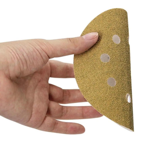 5 inch hook and loop sanding disc being held, featuring aluminum oxide grit for orbital sander projects.