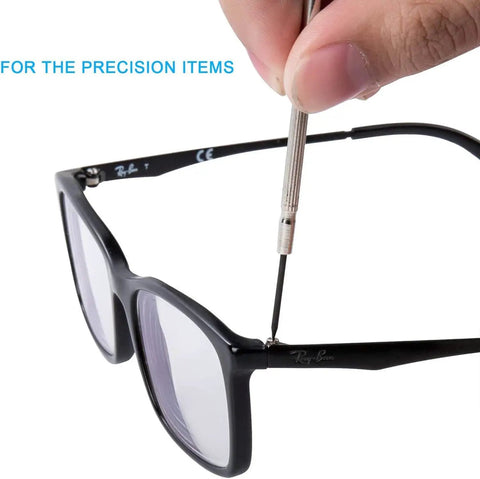 Using Ultra Handy Mini Screwdriver Set to tighten screw on eyeglass frame, close-up of precision repair with flathead bit.