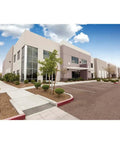 Modern commercial building exterior in daylight with landscaping