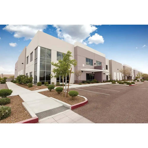 Modern commercial building exterior in daylight with landscaping