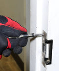 Mini Impact Driver Set With One Quarter Inch Drive For Tight Spaces being used on a door latch.