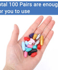 Hand holding multicolor 100 Sets Breakaway Clasps For Necklaces Safety Plastic Bead Connectors For Jewelry Making Multicolor Craft Supplies.