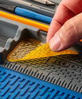 Hand removing glue from Silicone Project Tray Flexible Catch All Organizer For Small Parts Portable Tool Tray With Compartments