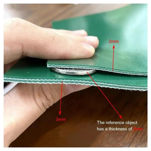 Close-up of green PVC conveyor belt showing thickness comparison, highlighting 3mm thickness, with hand holding edges.