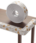 Heavy Duty Baby Proofing Edge Protectors 6.5Ft Super Dense Soft Rubber Foam Furniture Bumper Guards with playful designs on a table edge.