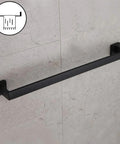 24 Inch Contemporary Stainless Steel Towel Bar Wall Mount With Slick Matte Black Finish installed on bathroom wall