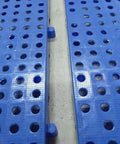 Close-up of lightweight plastic storage pallet with ventilated grid surface for garage basement kitchen and closet organization