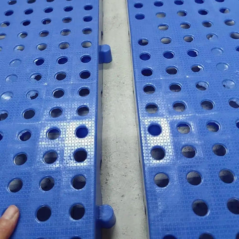 Close-up of lightweight plastic storage pallet with ventilated grid surface for garage basement kitchen and closet organization