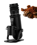 Top Tier Single Dose Coffee Grinder Featuring A Heavy Duty Aluminum Build And Premium 48MM Conical Burr With Sixty Step Micro Adjustments in black with coffee grounds.