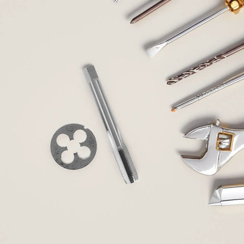 Rock Solid Precision Thread Tap And Die Set With Straight Flute Design For Handheld Convenience And Metal Construction, Perfect For Rapid Thread Repair And DIY Maintenance Tasks That You Can Actually Feel In Your Hands. steel tap, die, and drill bits on white background