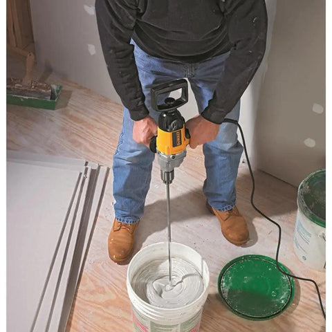 Person using Badass Torque One Half Inch Spade Handle Corded Drill With Nine Point Zero Amp Motor and Reversing Switch for mixing.