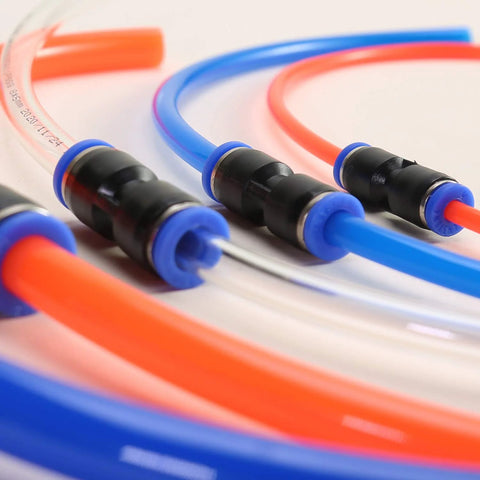Close-up of 40-piece push-to-connect pneumatic hose fittings with blue and orange tubing and black connectors.
