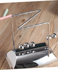 Z Shape Newton Cradle Pendulum Desk Toy For Home Office Decor, silver 5-ball model on wooden desk