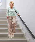 Premium Flush Handrail Set Stainless Steel Wall Mounted Indoor Outdoor Stair Railing With Heavy Duty Mounts Built Like A Tank And Rock Solid For Daily Projects, supporting elderly woman on stairs.