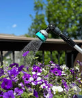 All In One Garden Hose Wand With 180 Degree Swivel Head And 10 Adjustable Spray Patterns watering purple flowers