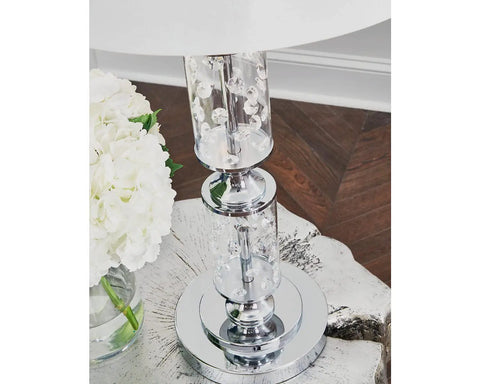 Close-up of Big Glam Crystal Bead Table Lamp With Clear Glass Tubes And Shiny Chrome Finish on wooden table