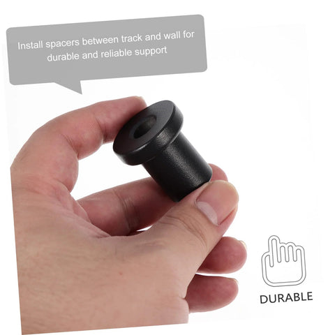 Hand holding a black iron spacer, part of the Four Pack Sliding Barn Door Track Spacers And Wall Track Connectors For Durable Support And Reliable Rolling Ideal Replacement Hardware For Barn Doors Garages Basements And More.