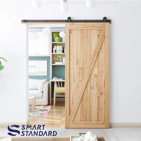 Rock Solid Six Foot Top Mount Sliding Barn Door Hardware Kit installed on wood door, living area view.