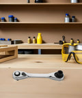 Rock Solid Mini Ratchet Wrench With 1/4 Inch Double Ended Reversible Socket And Knurled Finger Grip on a workbench.